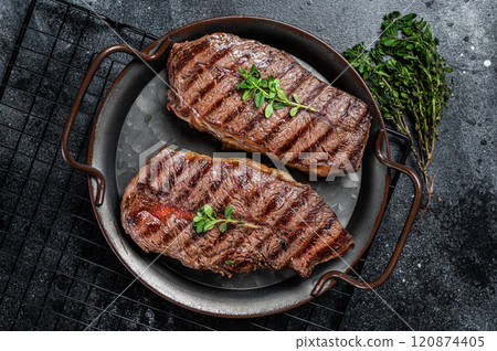 Grilled Top Blade or flat iron beef meat steaks. Black background. Top View 120874405