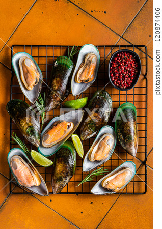 Raw green kiwi mussels in shells with herbs. Orange background. Top view 120874406