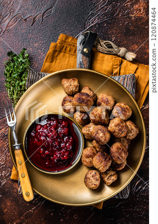Beef meatballs with lingonberries jam, swedish meatballs. Dark background. Top view Beef meatballs with lingonberries jam, swedish meatballs. Dark background. Top view 120874464