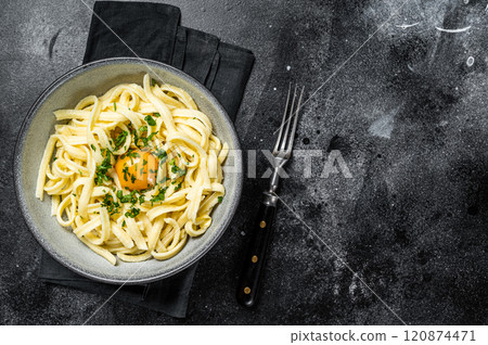 Traditional Bavarian Spaetzle egg Noodles with Butter and Parsley. Black background. Top view. Copy space 120874471