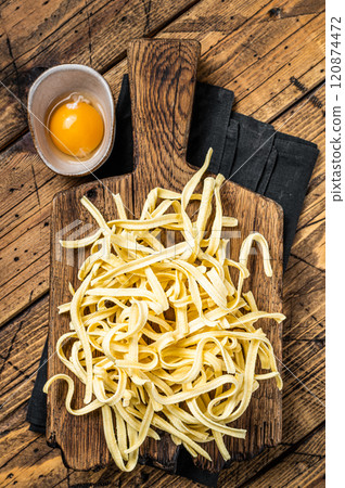 Cooking raw spaetzle egg noodle. Wooden background. Top view 120874472
