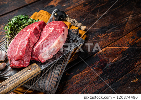 Dry aged Raw top blade beef meat steaks. Dark background. Top View. Copy space Dry aged Raw top blade beef meat steaks. Dark background. Top View. Copy space 120874480
