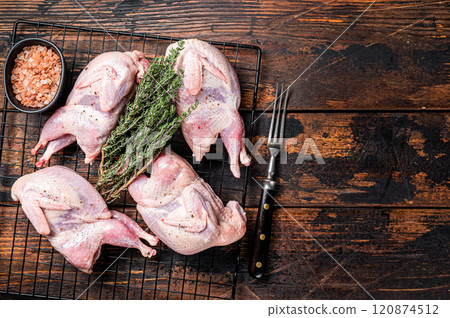 Farm eco friendly raw quails on kitchen table. Wooden background. Top view. Copy space Farm eco friendly raw quails on kitchen table. Wooden background. Top view. Copy space 120874512