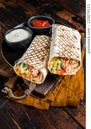 Shawarma, Shaurma chicken roll with vegetable salad. Wooden background. Top view Shawarma, Shaurma chicken roll with vegetable salad. Wooden background. Top view 120874513