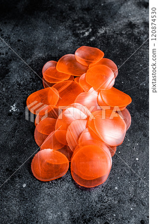 Raw kerupuk or prawn shrimp crackers, chips. Black background. Top view 120874530
