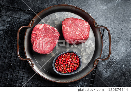Dry aged Raw steaks fillet Mignon, Beef tenderloin. Black background. Top view Dry aged Raw steaks fillet Mignon, Beef tenderloin. Black background. Top view 120874544