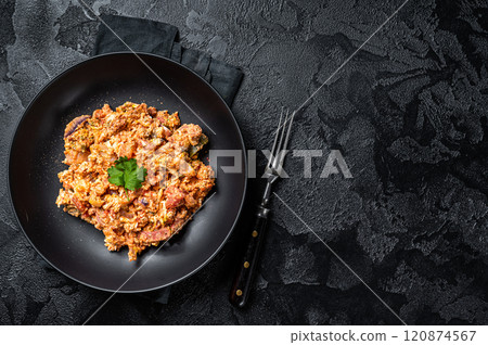 Turkish Menemen, Eggs with tomatoes, green peppers and green onion. Black background. Top view. Copy space 120874567