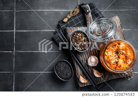Homemade kimchi in a glass jar, traditional Korean cuisine. Black background. Top view. Copy space 120874583