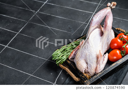 Game bird Raw Guineafowl, guinea fowl ready for cooking. Black background. Top view. Copy space Game bird Raw Guineafowl, guinea fowl ready for cooking. Black background. Top view. Copy space 120874590