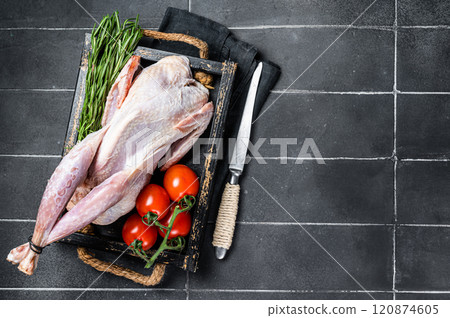 Game bird Raw Guineafowl, guinea fowl ready for cooking. Black background. Top view. Copy space Game bird Raw Guineafowl, guinea fowl ready for cooking. Black background. Top view. Copy space 120874605