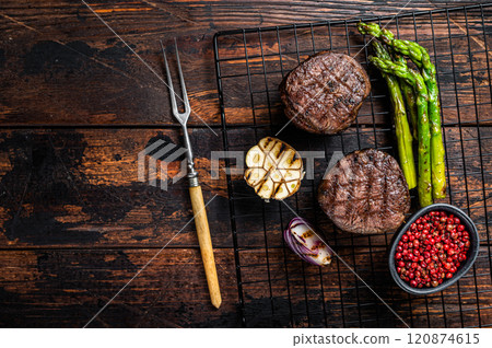 Fillet Mignon grilled Steak with asparagus, beef tenderloin meat. Wooden background. Top view. Copy space Fillet Mignon grilled Steak with asparagus, beef tenderloin meat. Wooden background. Top view. Copy space 120874615