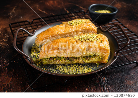 Turkish Havuc Dilim Baklava with pistachio. Dark background. Top view 120874650