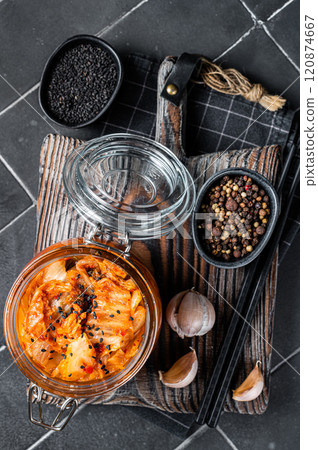 Homemade kimchi in a glass jar, traditional Korean cuisine. Black background. Top view Homemade kimchi in a glass jar, traditional Korean cuisine. Black background. Top view 120874667