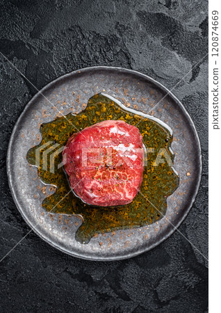 Fillet Mignon prime beef steak, raw dry aged marble meat with herbs and spices ready for cooking. Black background. Top view Fillet Mignon prime beef steak, raw dry aged marble meat with herbs and spices ready for cooking. Black background. Top view 120874669