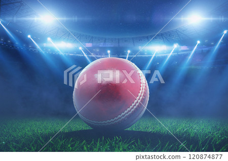 leather red cricket ball lies on grass in stadium with blue floodlights during cricket tournament. Cricket Championship, creative idea 120874877