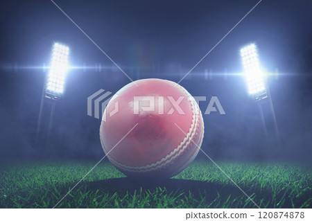 leather red cricket ball lies on grass in stadium with floodlights. Cricket Championship, creative idea. Sport Card Concept 120874878