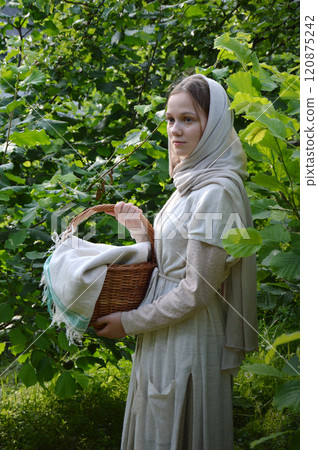 Young girl with basket in the park 120875242