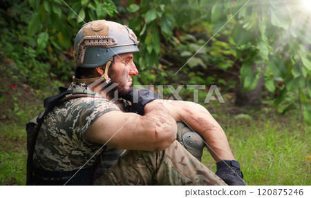 Lone sad soldier sitting in the forest 120875246