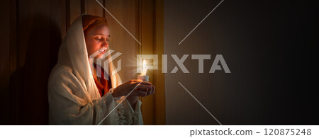 Young pretty girl with a candle 120875248