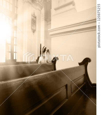 Girl sitting in the church Girl sitting in the church 120875255