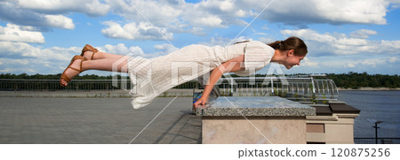 Girl in the city did a horizontal handstand Girl in the city did a horizontal handstand 120875256