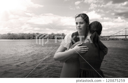 Insincere smile of a hugging girl Insincere smile of a hugging girl 120875259