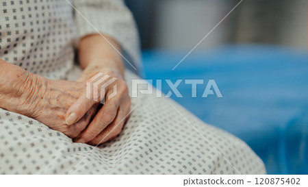 Hands of old woman with serious health issues sitting on hospital bed. Elderly patient feeling pain. Hands of old woman with serious health issues sitting on hospital bed. Elderly patient feeling pain. 120875402