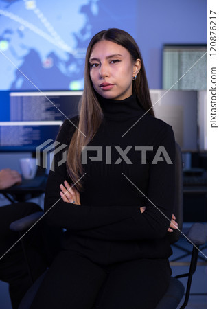 Portrait of a confident female Cybersecurity Analyst or Manager in large Cyber Security Operations Center SOC handling Threats Portrait of a confident female Cybersecurity Analyst or Manager in large Cyber Security Operations Center SOC handling Threats 120876217