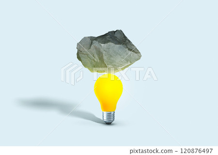 Stone put on yellow light bulb floating on blue background. minimal creative idea concept. Balance, creative idea. Startup, concept 120876497
