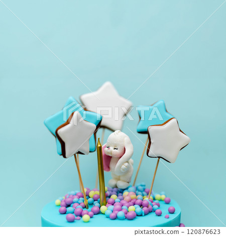 A delightful cake showcases a playful bunny surrounded by colorful star-shaped cookies. Vibrant pastel decorations create a joyful atmosphere perfect for a celebration. A delightful cake showcases a playful bunny surrounded by colorful star-shaped cookies. Vibrant pastel decorations create a joyful atmosphere perfect for a celebration. 120876623