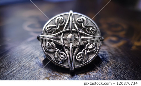 A silver and black metal pin with a design of a cross and a star 120876734