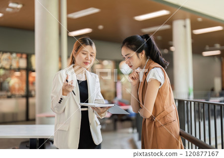 Professional Business Women Collaborating in Modern Office Environment for Strategic Planning and Decision Making 120877167