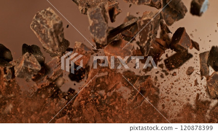 Freeze motion of flying group of raw chocolate pieces. Freeze motion of flying group of raw chocolate pieces. 120878399