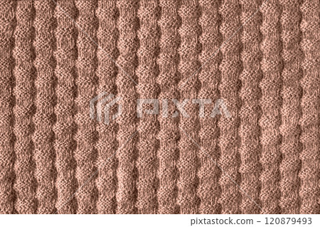 Demonstrating the colors of 2025 - Mocha Mousse. Knitted brown background. Large knitted fabric with a pattern. Close-up of a knitted blanket. Color concept. Demonstrating the colors of 2025 - Mocha Mousse. Knitted brown background. Large knitted fabric with a pattern. Close-up of a knitted blanket. Color concept. 120879493