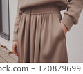 Mocha mousse color woman street style outfit. Soft warm clothes autumn fall look. Trendy color palette of the year photo 120879699