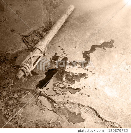 Stone axe with red blood 120879783