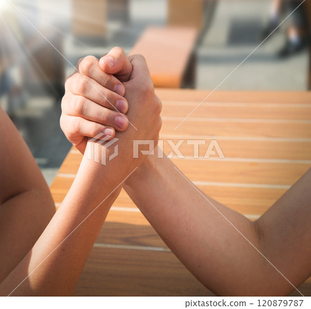 Hand wrestling contest of two girls 120879787