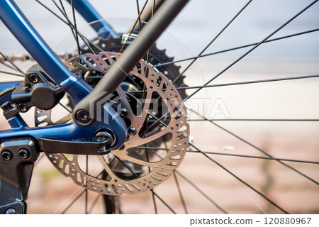 Bicycle disk brakes close up, grey metal disc attached to bike wheel. Hydraulic disk brakes on bicycle wheel. e-bike. 120880967