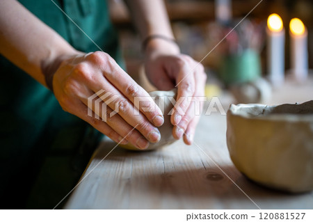 Work with your hands, artist female molding raw clay for sculpturing and shaping pottery or ceramics Work with your hands, artist female molding raw clay for sculpturing and shaping pottery or ceramics 120881527
