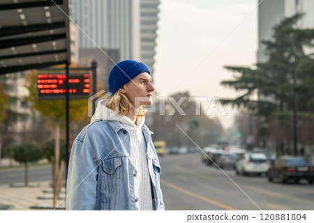 Pensive stylish trendy hipster guy looking into distance, waiting for taxi, bus Pensive stylish trendy hipster guy looking into distance, waiting for taxi, bus 120881804