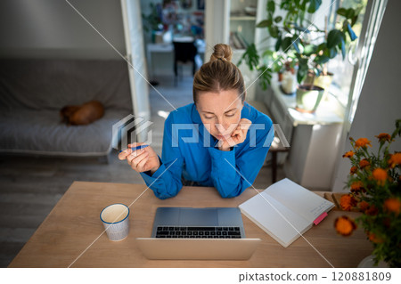 Dedicated woman organize lesson plans and learning with laptop and notepads. Adult student and exams 120881809