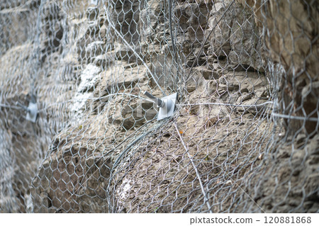 Landslide and rock sliding prevention in Turkey, reinforcing mountain slope with metal mesh. Landslide and rock sliding prevention in Turkey, reinforcing mountain slope with metal mesh. 120881868