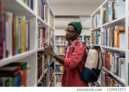 Thoughtful African American student man in glasses choosing book in college library or bookstore Thoughtful African American student man in glasses choosing book in college library or bookstore 120881971