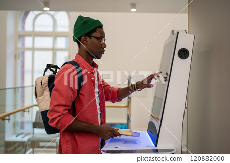 Progressive young man using self-service electronic terminal to pay in store without salesperson Progressive young man using self-service electronic terminal to pay in store without salesperson 120882000