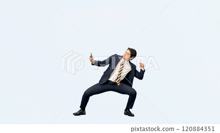 Full-body photo of a male business person dancing while using a smartphone Full-body photo of a male business person dancing while using a smartphone 120884351