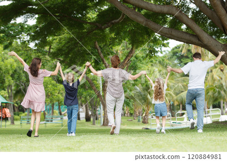 Caucasian family parent and their children picnic at the park in morning. 120884981