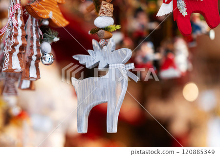 Grey Wooden Reindeer Ornament with Ribbon in Festive Scene Grey Wooden Reindeer Ornament with Ribbon in Festive Scene 120885349