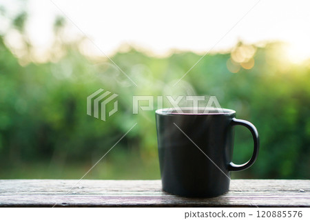 Beautiful sunrise lighting in the morning with a hot coffee and Moka Pot close up with copyspace. Beautiful natural sun lighting bokeh and coffee cup in the morning. Beautiful sunrise lighting in the morning with a hot coffee and Moka Pot close up with copyspace. Beautiful natural sun lighting bokeh and coffee cup in the morning. 120885576