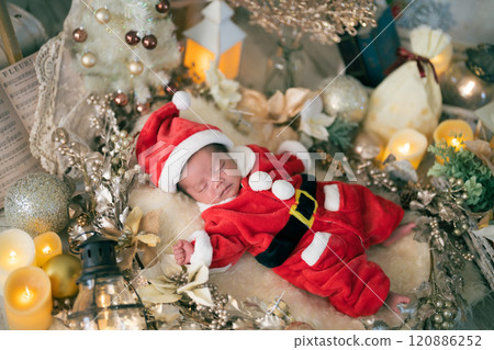 A newborn baby aged 0 months old takes newborn photos wearing Santa clothes in a Christmas photo set A newborn baby aged 0 months old takes newborn photos wearing Santa clothes in a Christmas photo set 120886252