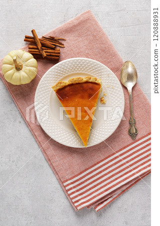 Flat lay composition with piece of fresh delicious homemade pumpkin pie and space for text on napkin Flat lay composition with piece of fresh delicious homemade pumpkin pie and space for text on napkin 120888931